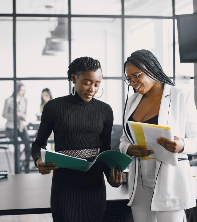 multi ethnic business colleagues reviewing paper documents while